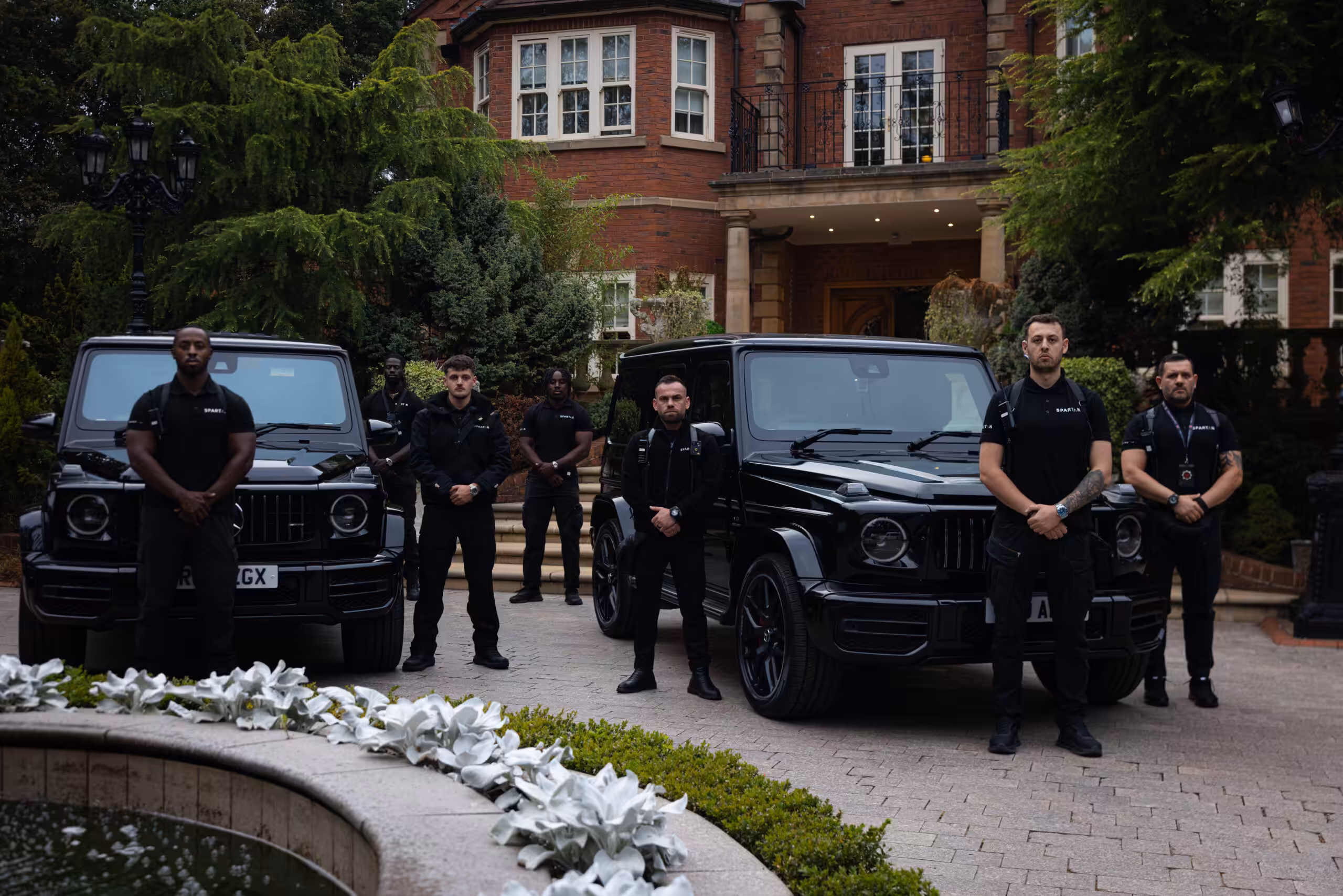 Spartan private security company team beside protection vehicles in London
